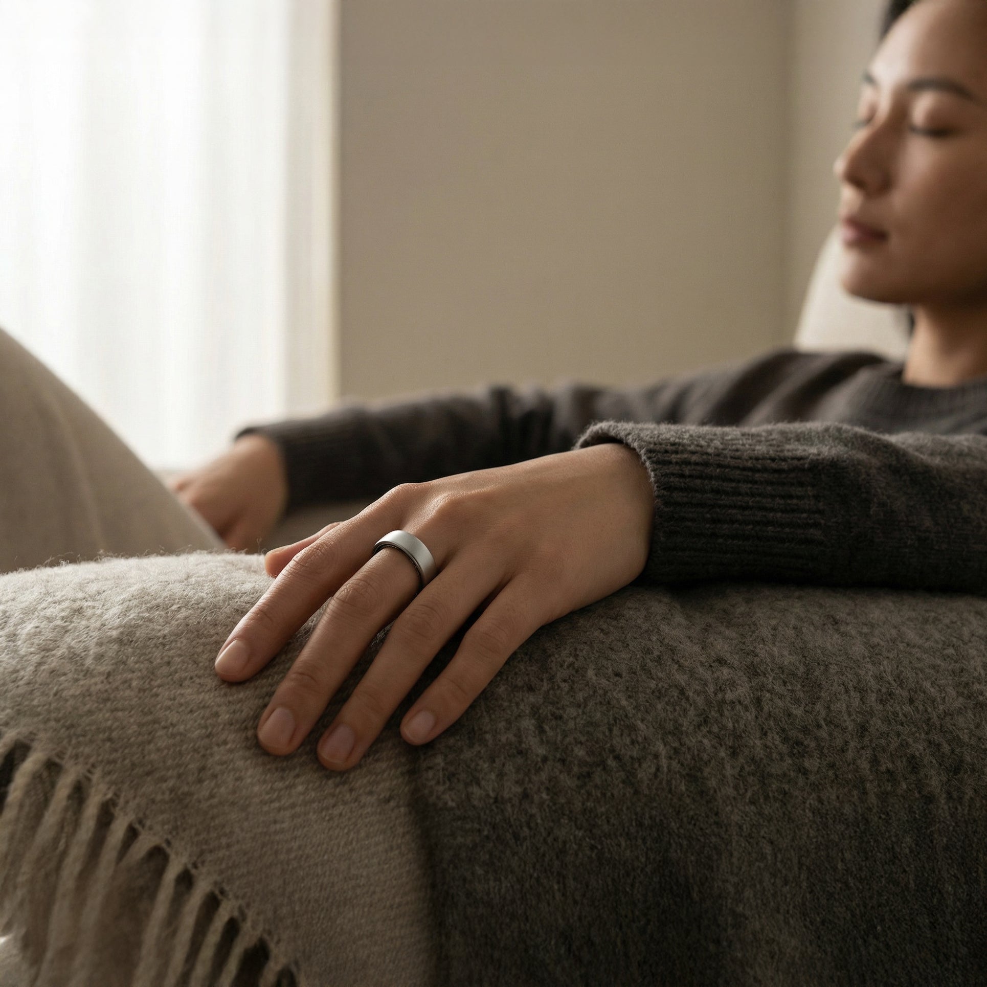 Woman practicing mindfulness and stress management while wearing a health tracking smart ring.